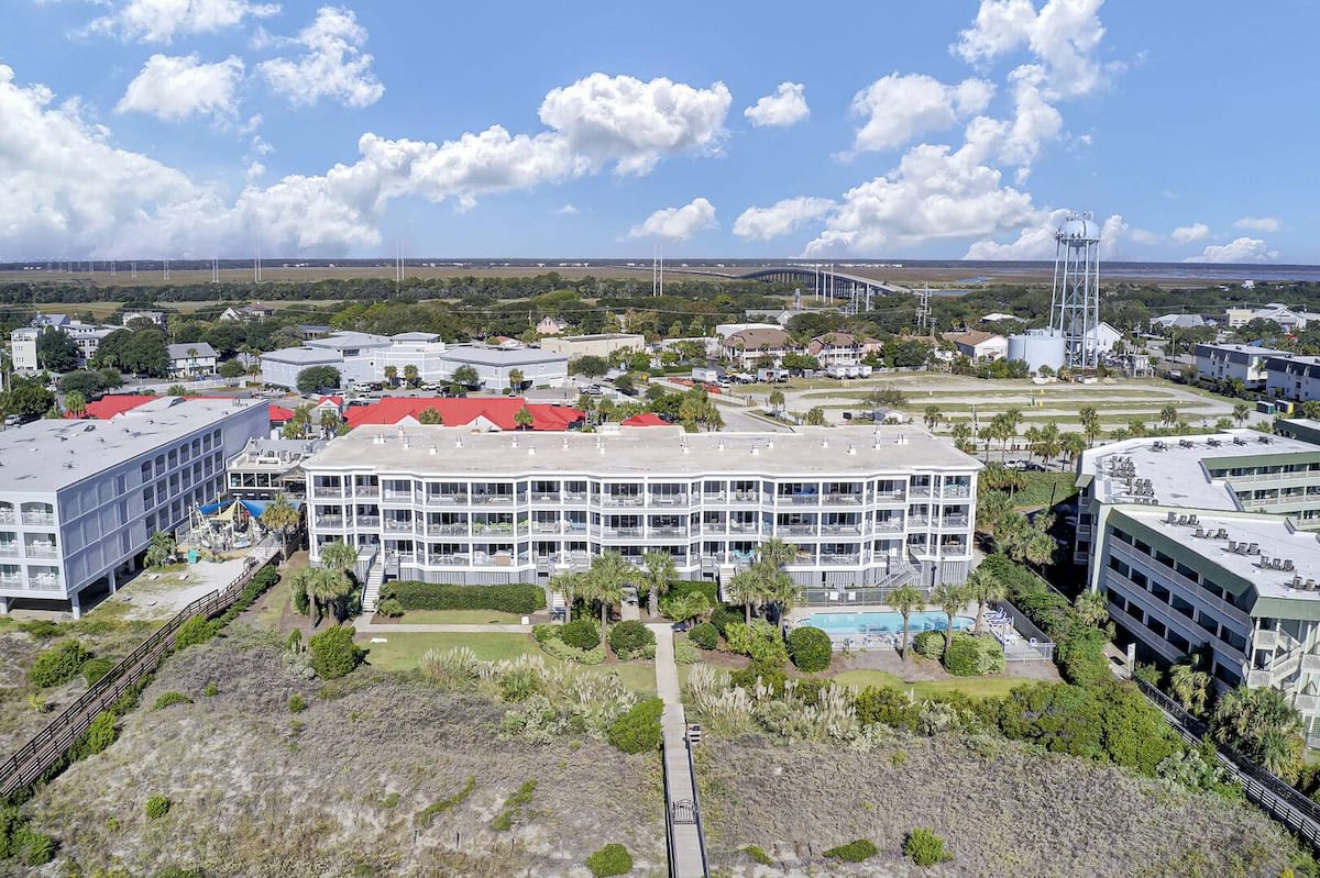 Aerial showing full building, pool, water tower, and Isle of Palms town