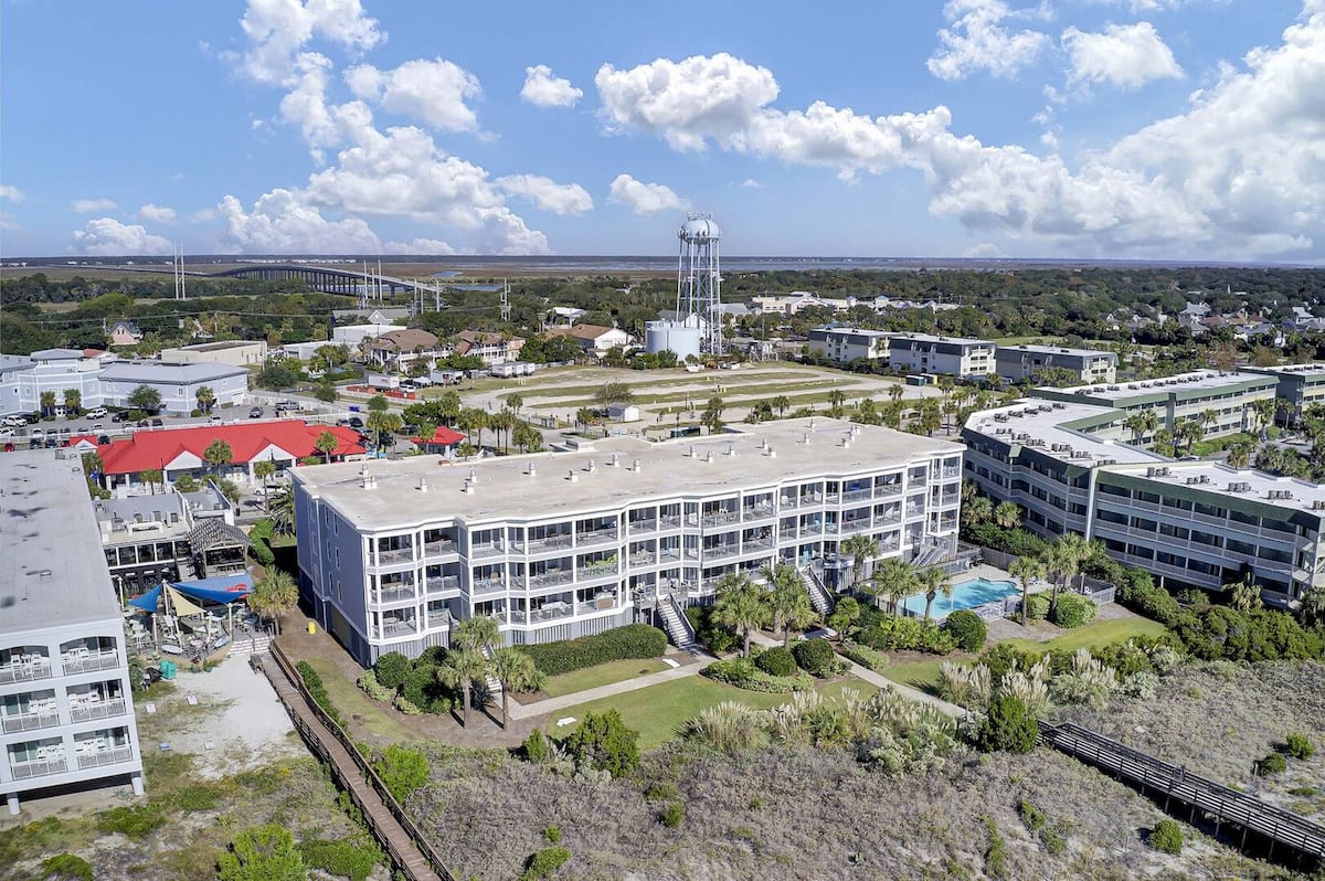 Aerial view from beach showing pool courtyard, water tower, and IOP Connector bridge
