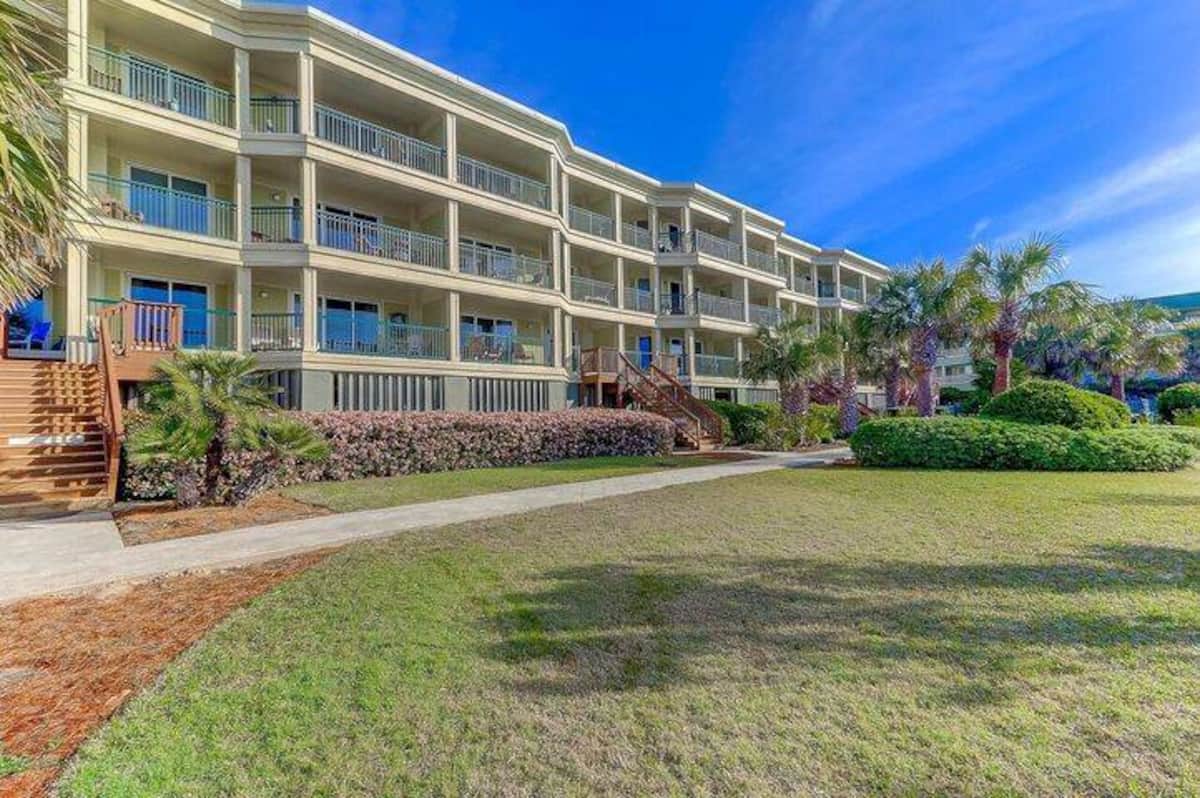 1140 Ocean Blvd ocean side with wraparound balconies and landscaped grounds